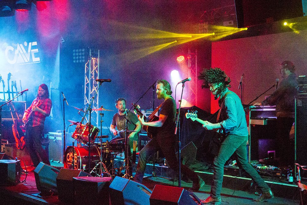 Ha Ha Tonka peform at The Cave in Big Bear, California, 4/1/17. The lineup for this album included two newcomers who left their marks on the studio sessions and helped reinvigorate the band's always lively stage shows. Mike Reilly is center-left on drums, while James Cleare is far right on keys. Photo by Jason D. 'Diesel' Hamad/No Surf Music.